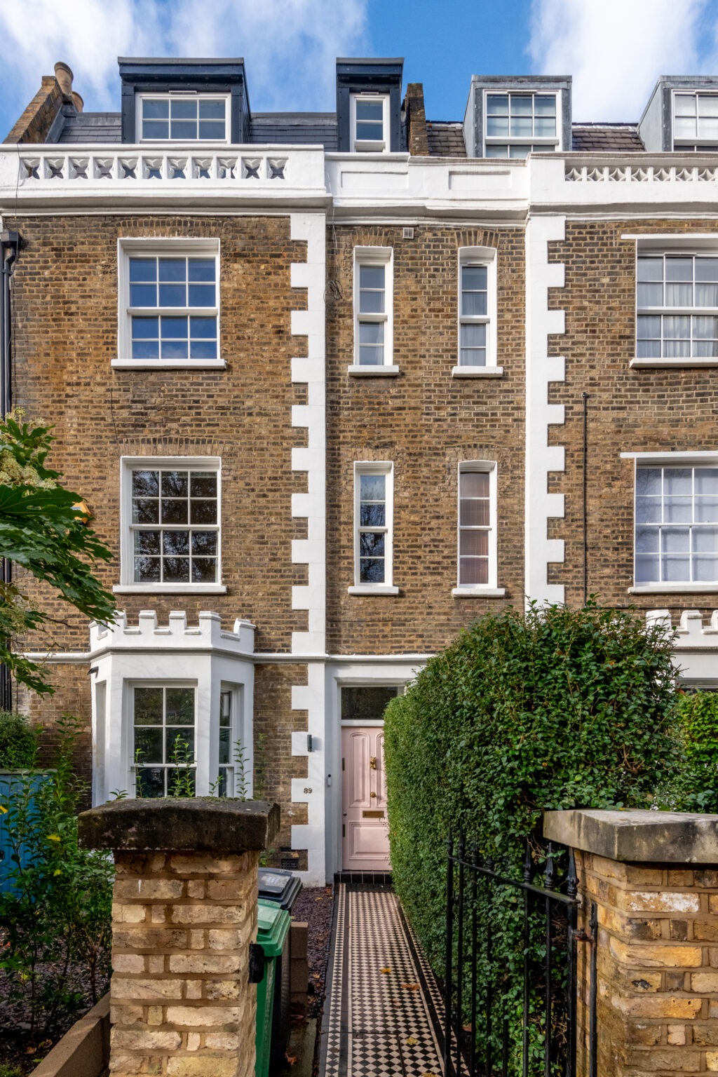 Victorian terraced house exterior with new loft conversion dormers, London stock brick and white render