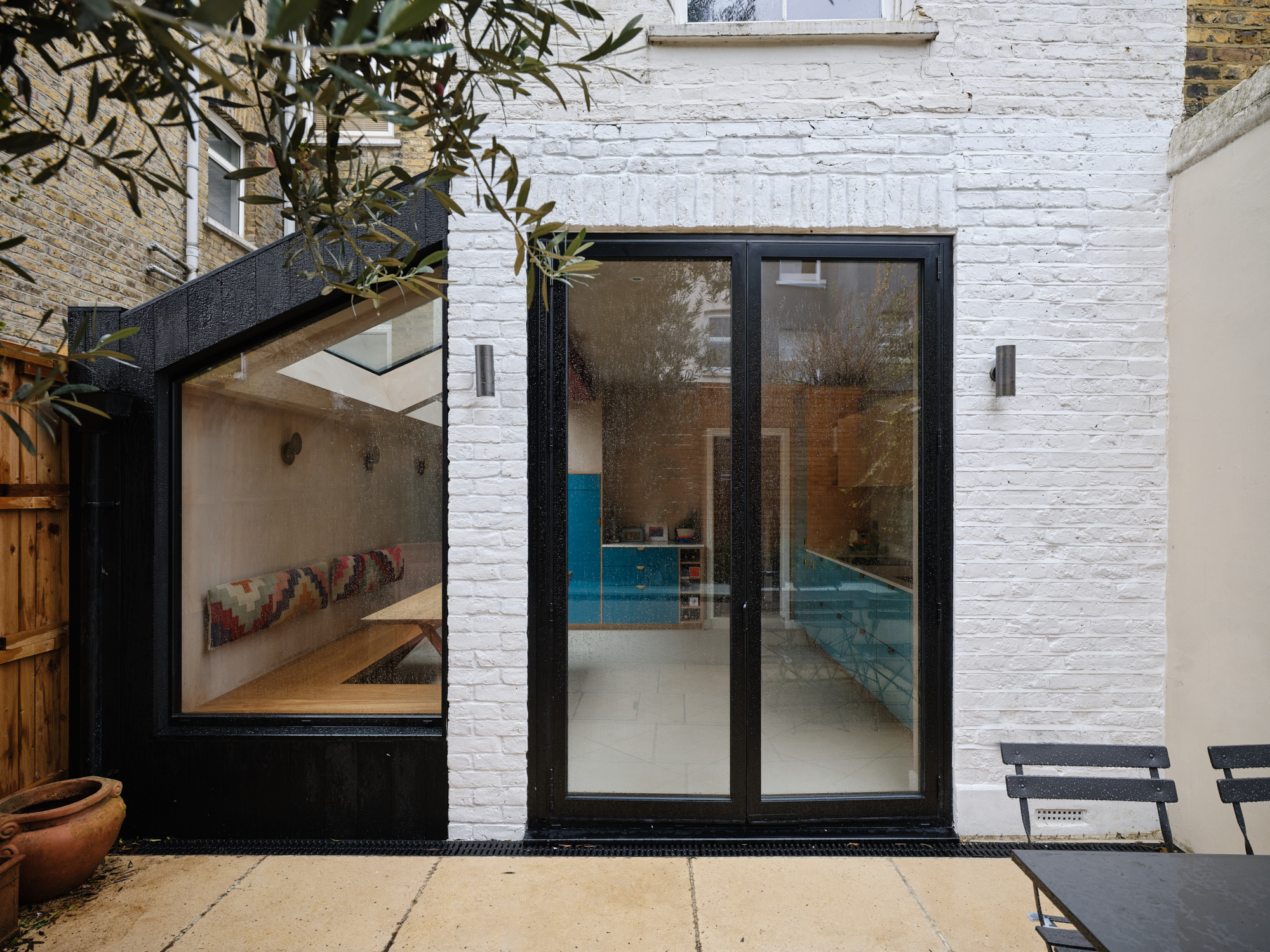 Rear elevation with black aluminium doors and corner window to kitchen extension