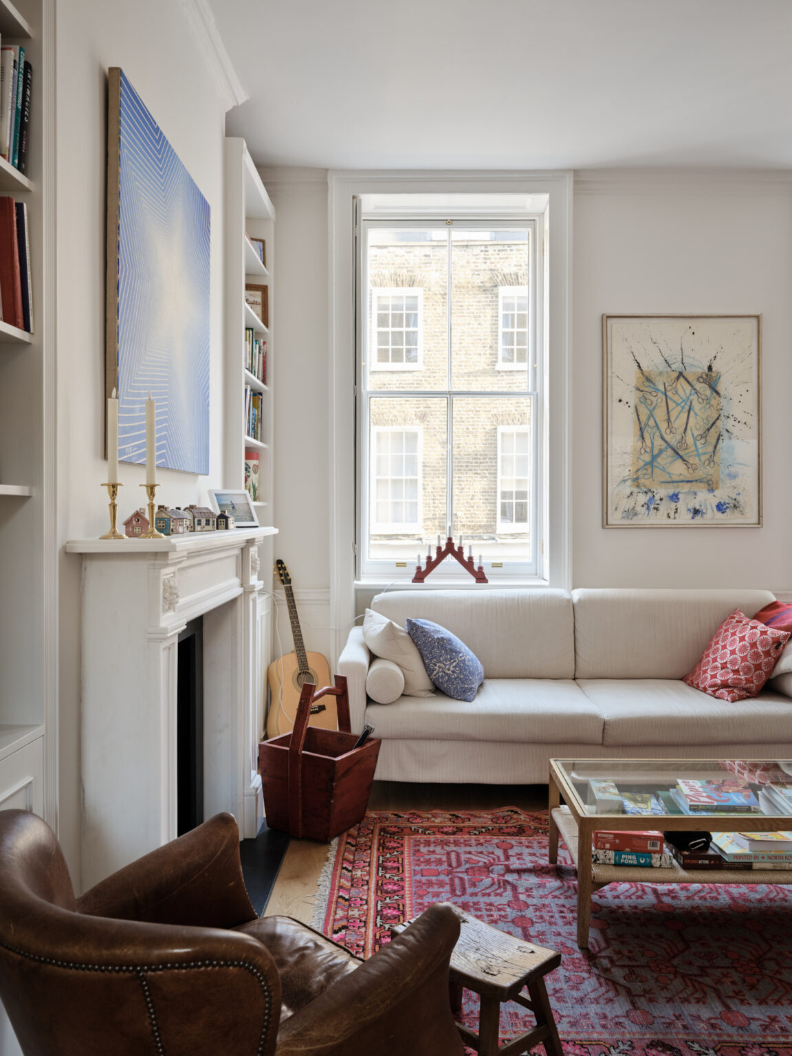 Georgian living room with contemporary artwork and period fireplace in Marylebone London
