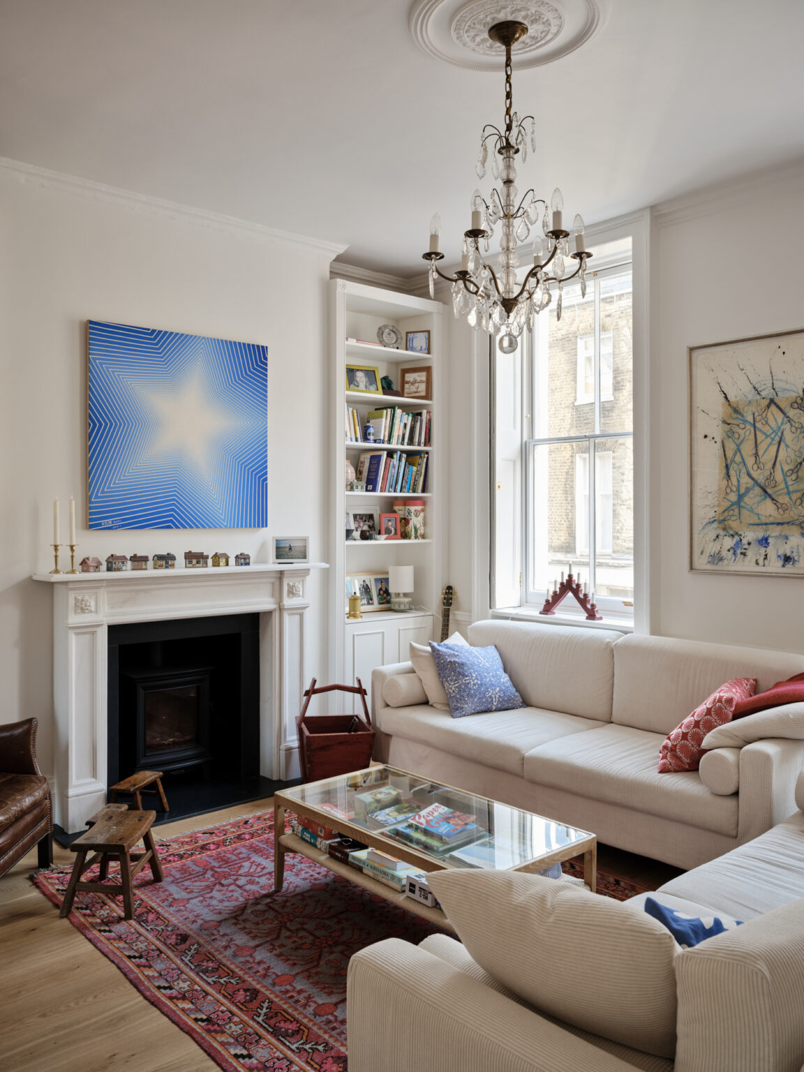 Marylebone living room with tall Georgian sash windows chandelier and bookshelves