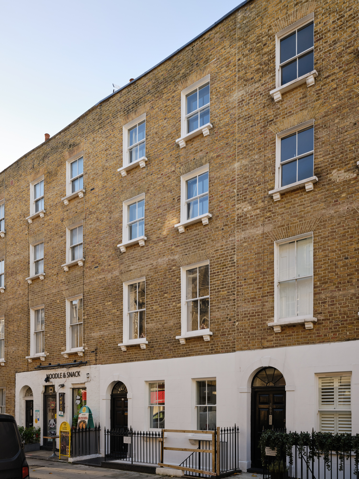 Georgian townhouse facade with yellow brick and white sash windows in Marylebone London